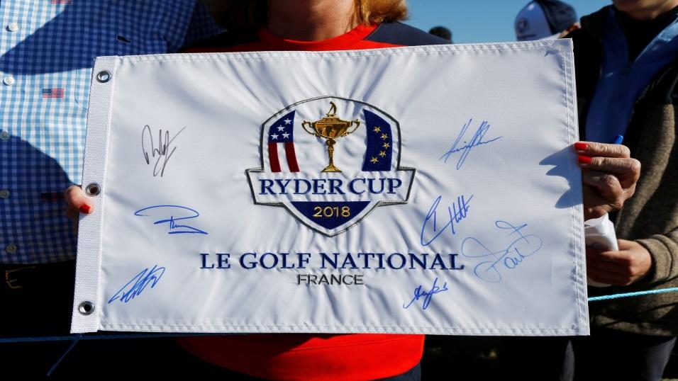 A fan holds an autographed Ryder Cup flag in Paris